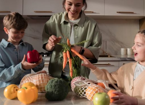 A family enjoys quality time in the kitchen, preparing a meal with fresh vegetables.